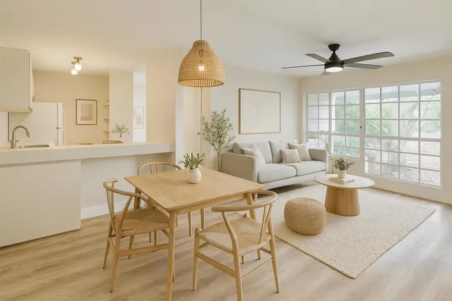 a kitchen with a table chairs and white cabinets