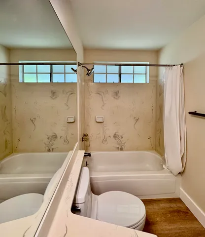 a bathroom with a bathtub and a shower