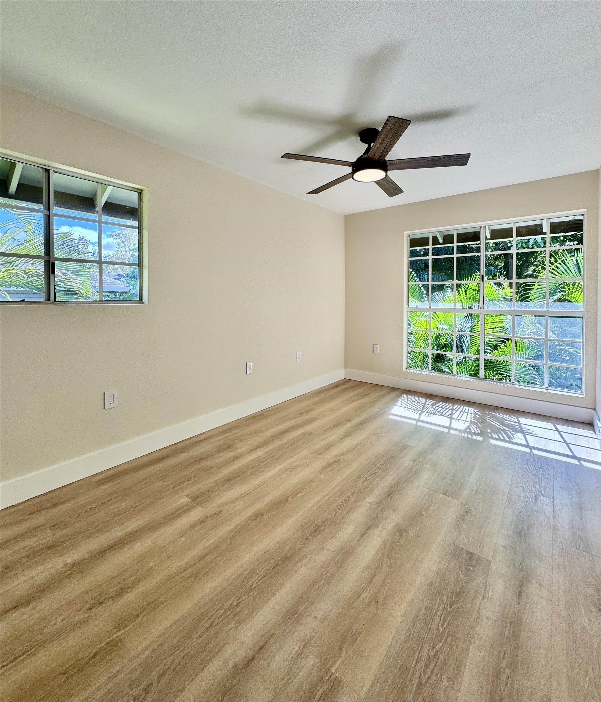 160 Keonekai Road, Unit 13208 Kihei, HI 96753 - Photo 4 of 21 a view of an empty room with wooden floor and fan