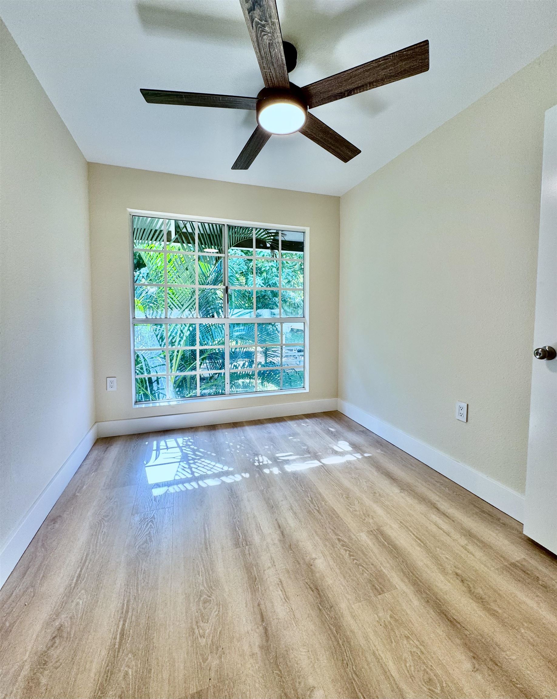 160 Keonekai Road, Unit 13208 Kihei, HI 96753 - Photo 6 of 21 a view of an empty room with wooden floor and a window