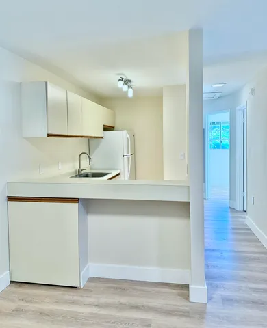 a kitchen with wooden floor