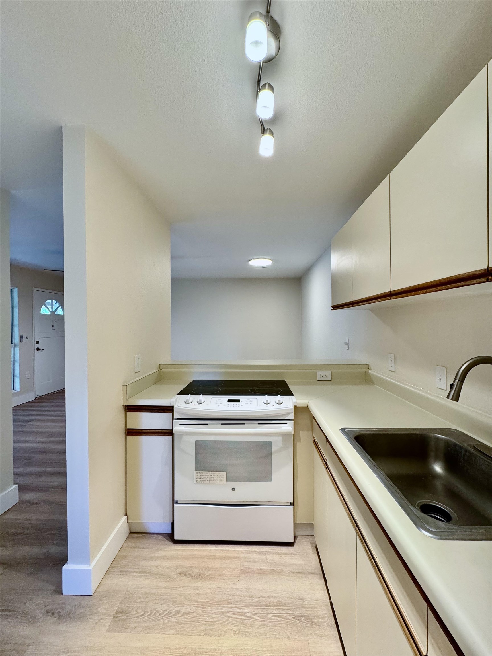 160 Keonekai Road, Unit 13208 Kihei, HI 96753 - Photo 8 of 21 a kitchen with a stove sink and cabinets