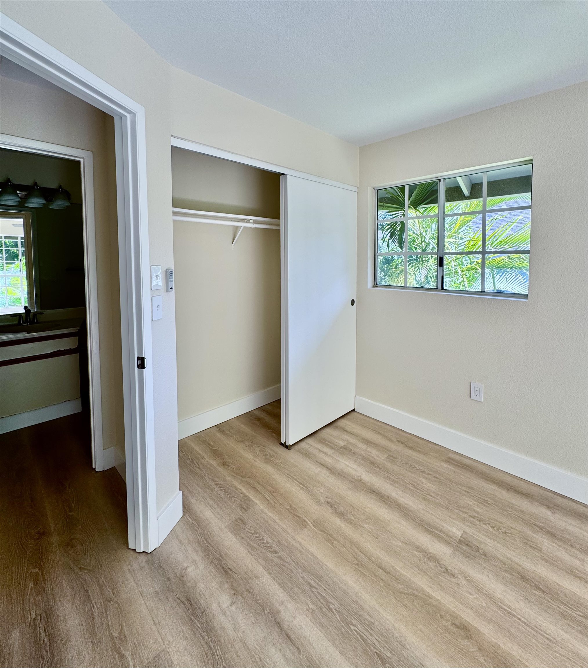 160 Keonekai Road, Unit 13208 Kihei, HI 96753 - Photo 10 of 21 an empty room with wooden floor a ceiling fan and windows