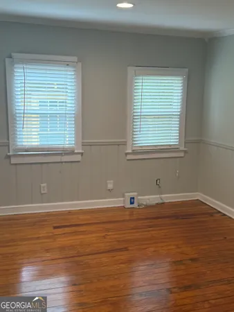 a view of a room with wooden floor and a window