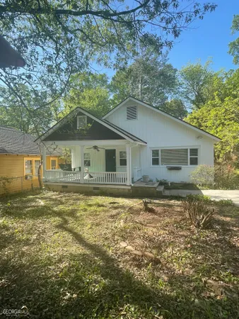 a front view of a house with a garden