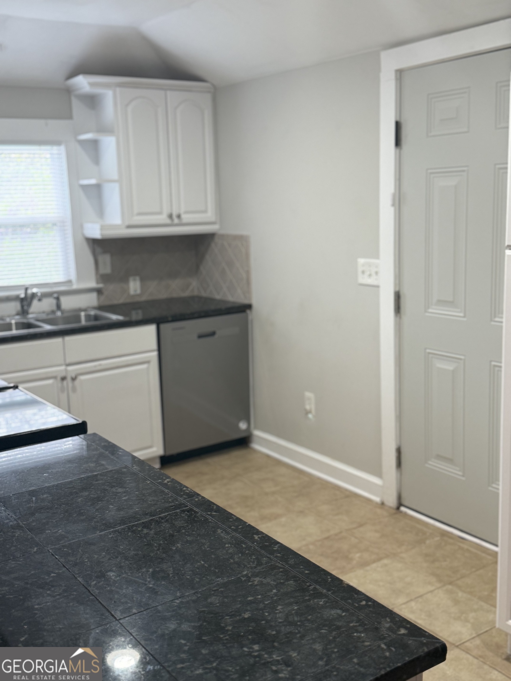 1750 Linwood Avenue East Point, GA 30344 - Photo 22 of 27 a kitchen with granite countertop a sink and a stove