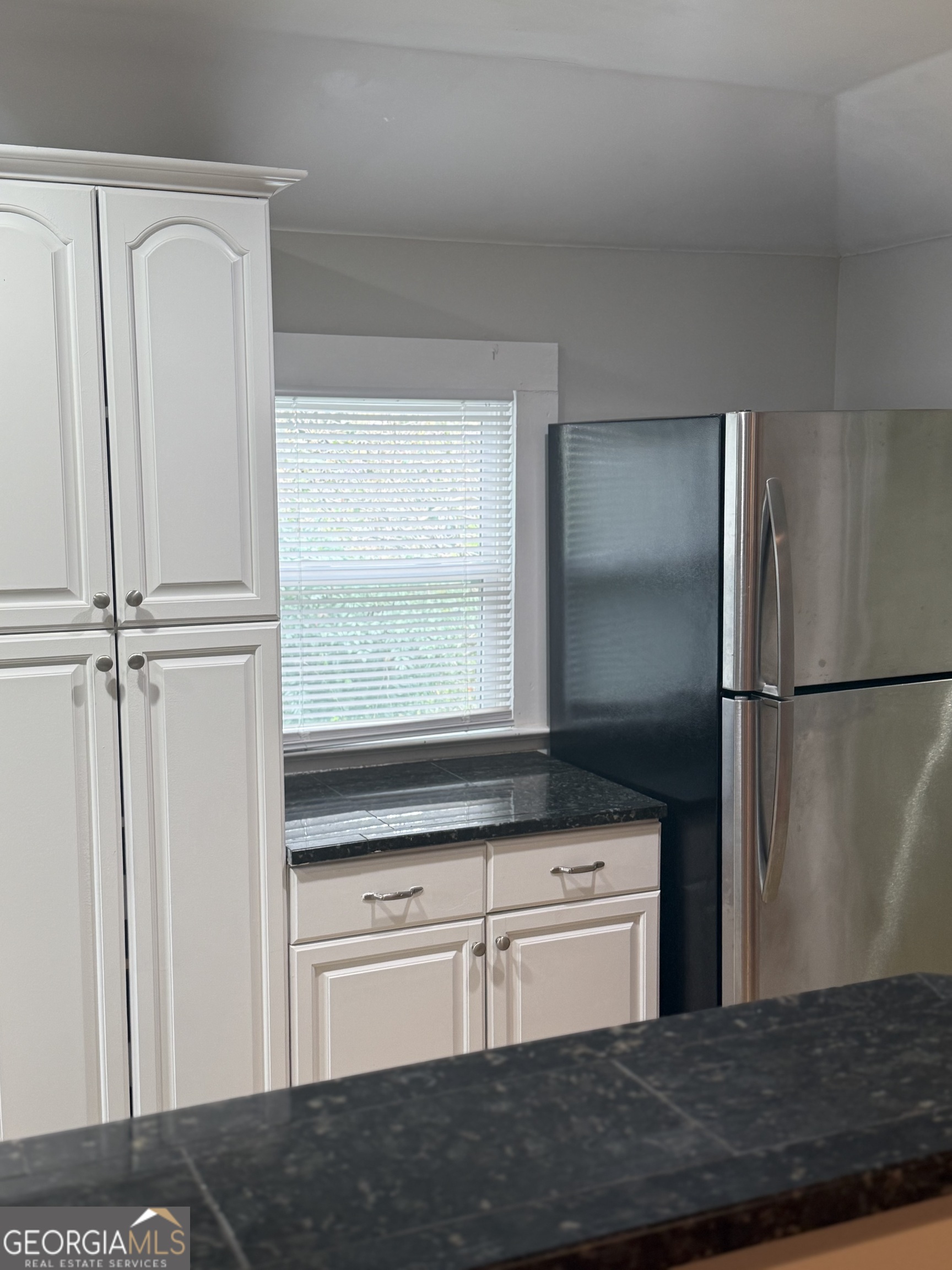 1750 Linwood Avenue East Point, GA 30344 - Photo 24 of 27 a kitchen with granite countertop a refrigerator and cabinets