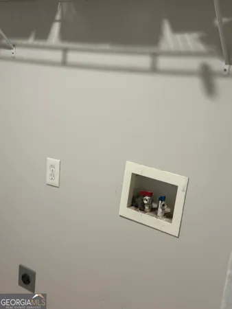 a white wall with a refrigerator in it
