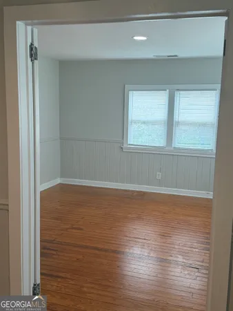 a view of a room with wooden floor and window