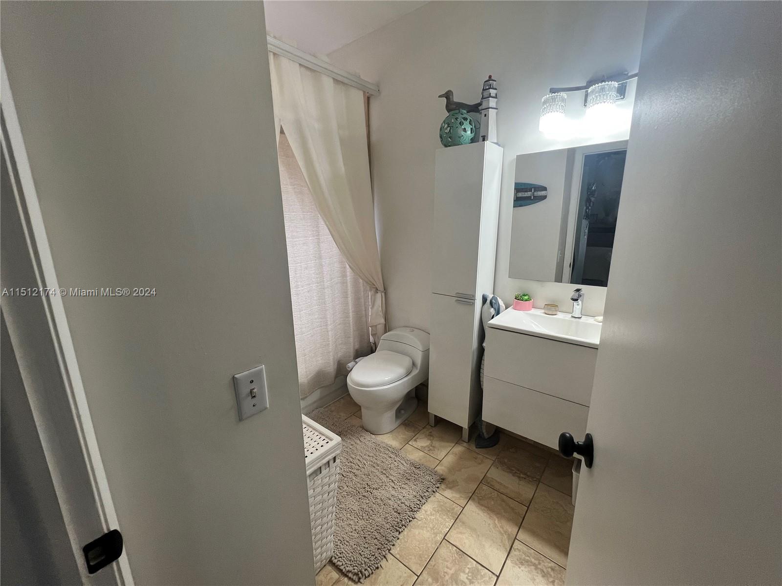 8118 Northwest 200th Street Hialeah, FL 33015 - Photo 11 of 24 a bathroom with a sink a toilet and mirror
