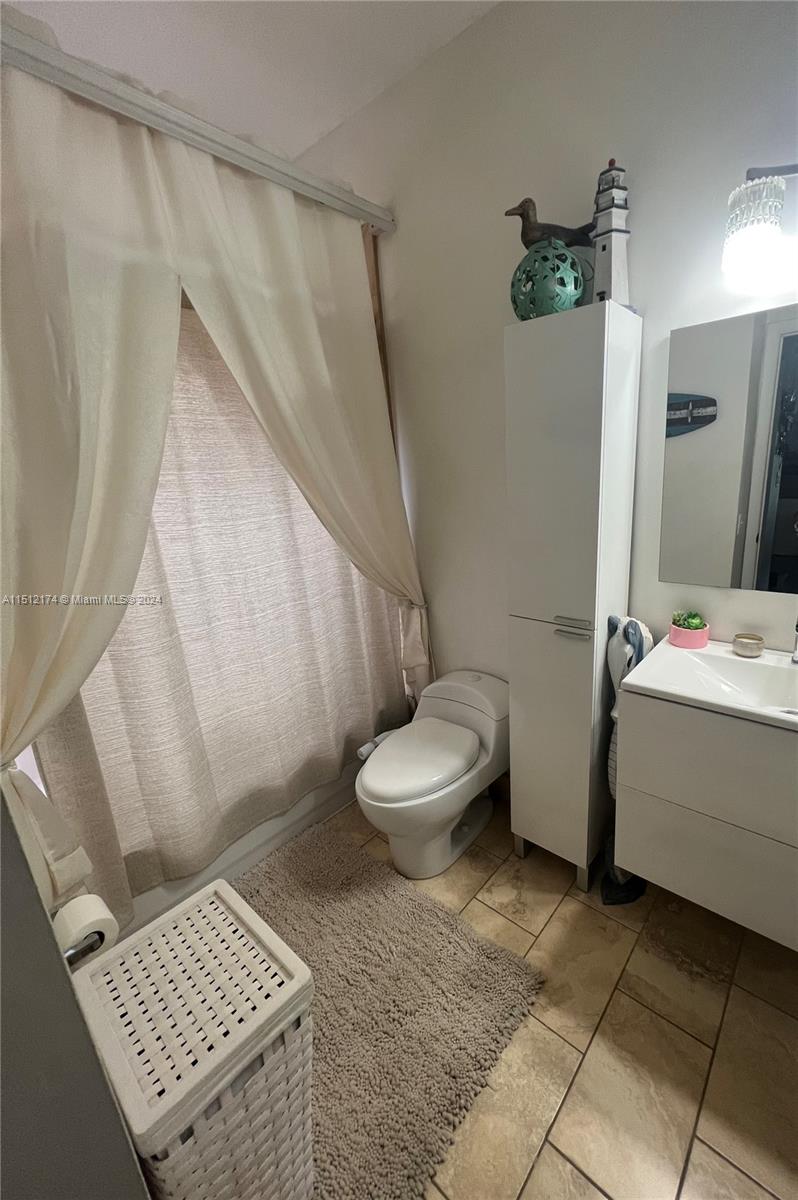 8118 Northwest 200th Street Hialeah, FL 33015 - Photo 12 of 24 a bathroom with a sink toilet and shower