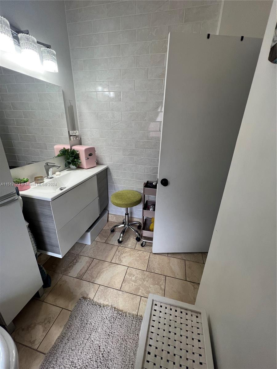 8118 Northwest 200th Street Hialeah, FL 33015 - Photo 14 of 24 a room with a table chairs and utility