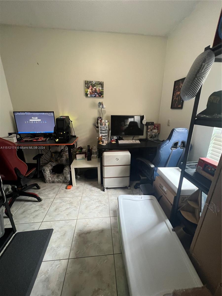 8118 Northwest 200th Street Hialeah, FL 33015 - Photo 18 of 24 a living room with furniture and a piano