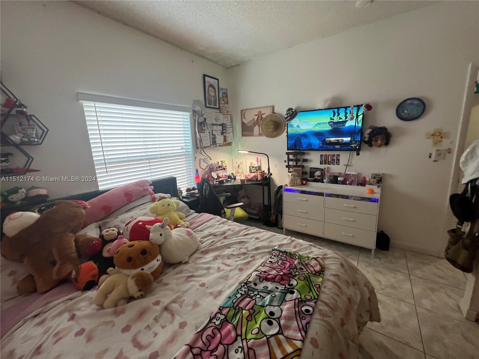 8118 Northwest 200th Street Hialeah, FL 33015 - Photo 20 of 24 a bedroom with a bed and a window