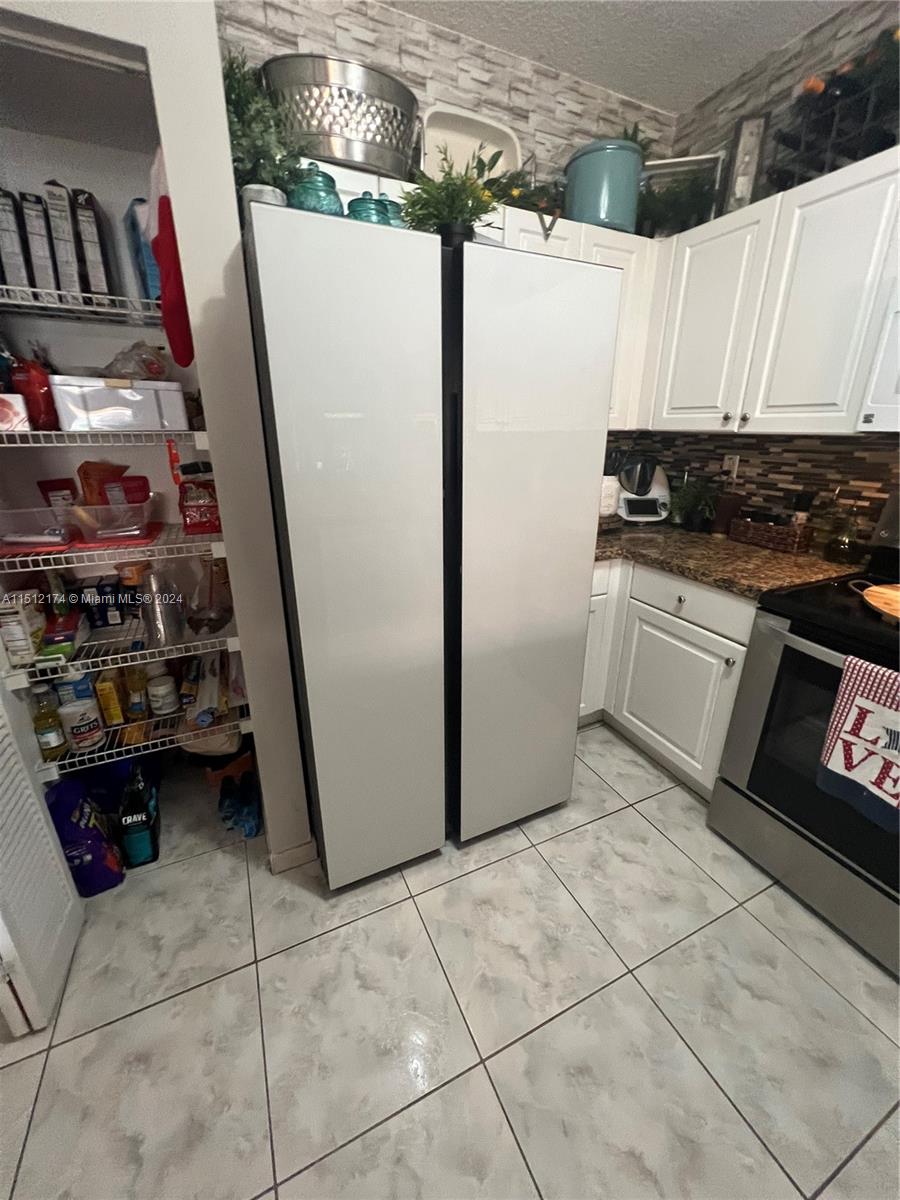 8118 Northwest 200th Street Hialeah, FL 33015 - Photo 6 of 24 a kitchen with a refrigerator and a stove