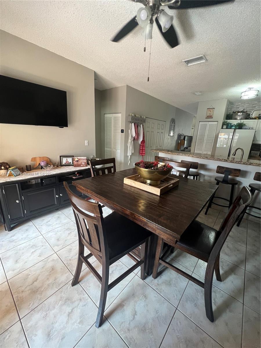 8118 Northwest 200th Street Hialeah, FL 33015 - Photo 9 of 24 a kitchen with a table and chairs in it
