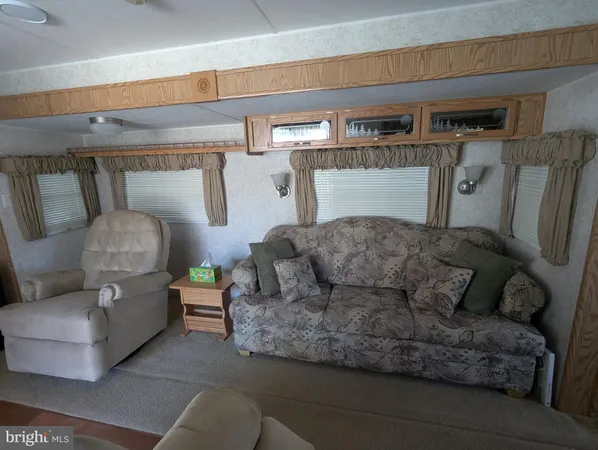 a view of walk in closet with wooden floor and cabinet