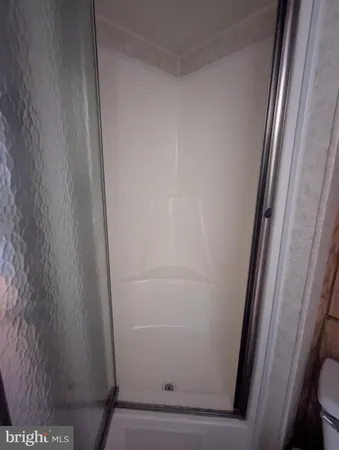 a living room with a bed and a television