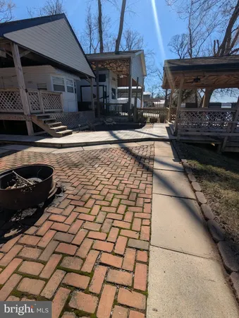 a view of a backyard with seating space
