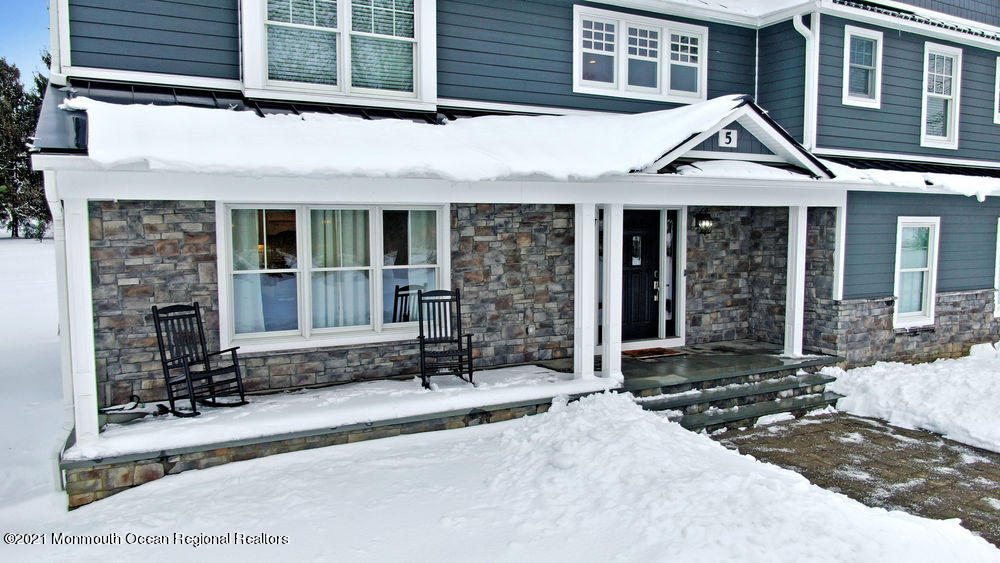 5 Cedar Drive Colts Neck, NJ 07722 - Photo 2 of 41 a front view of a house with a porch