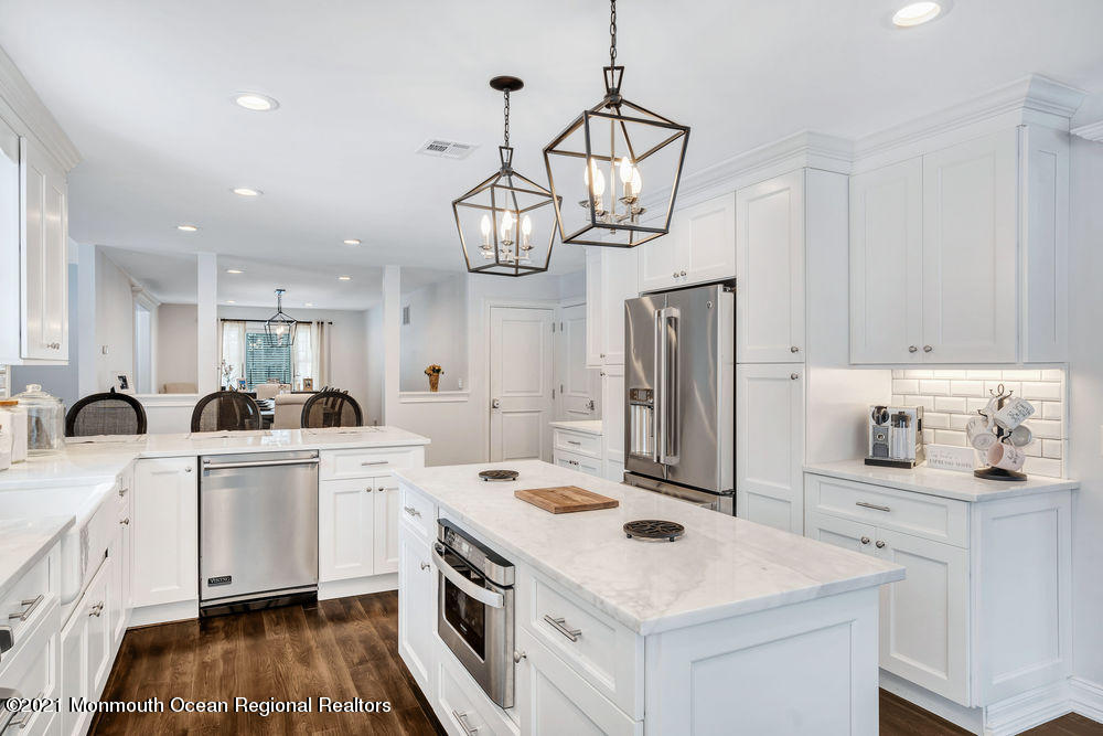 5 Cedar Drive Colts Neck, NJ 07722 - Photo 11 of 41 a kitchen that has a lot of white cabinets and stainless steel appliances
