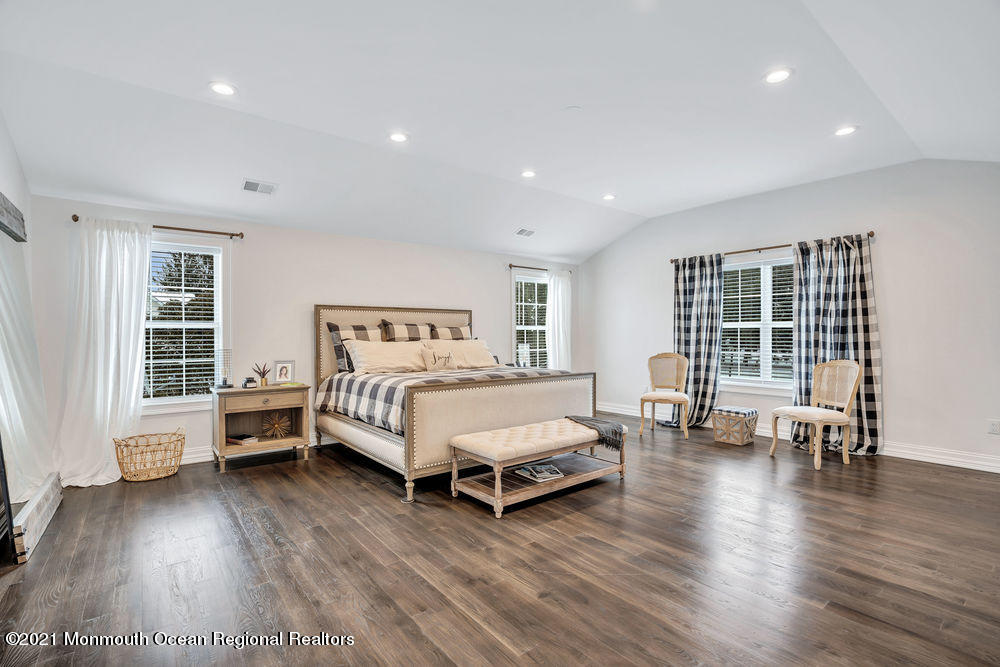 5 Cedar Drive Colts Neck, NJ 07722 - Photo 23 of 41 a spacious bedroom with a bed and a chair