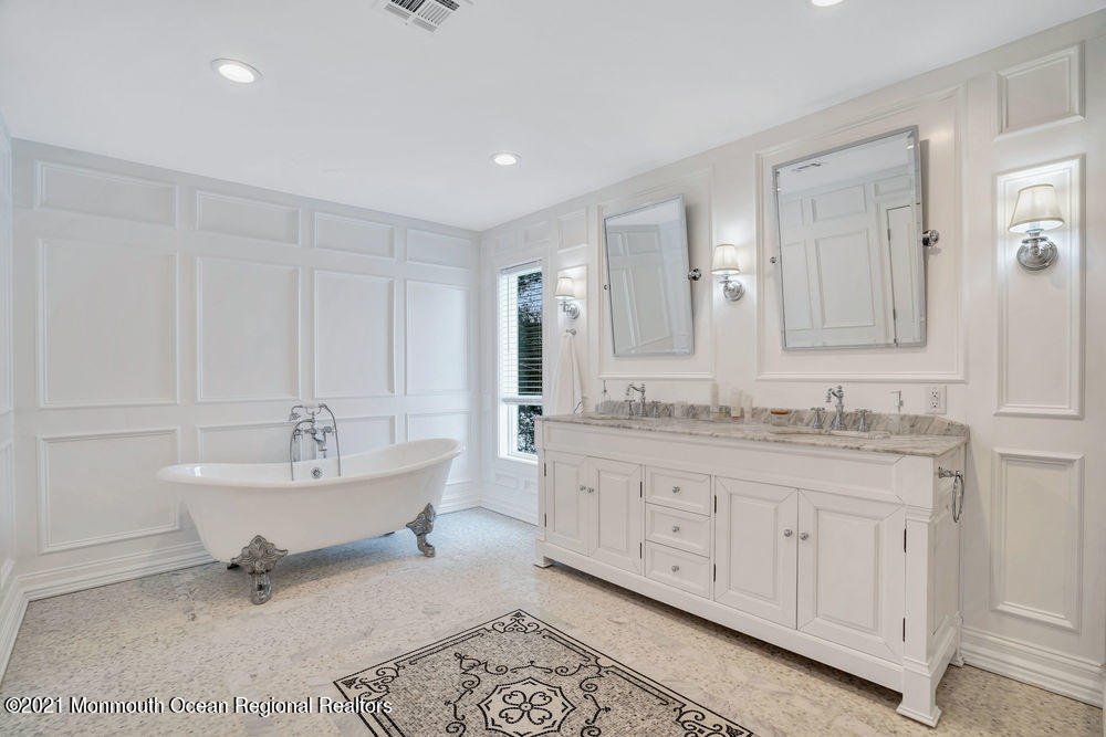 5 Cedar Drive Colts Neck, NJ 07722 - Photo 26 of 41 a spacious bathroom with a granite countertop sink a mirror and a bathtub