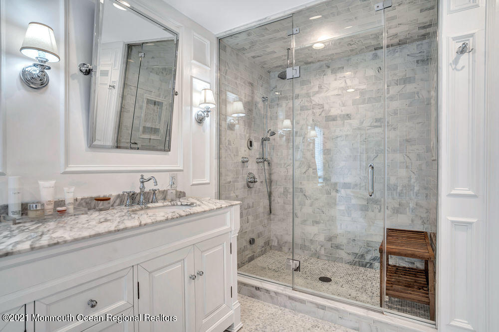 5 Cedar Drive Colts Neck, NJ 07722 - Photo 27 of 41 a bathroom with a shower sink and mirror
