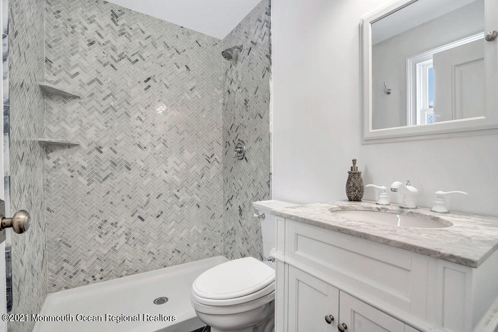 5 Cedar Drive Colts Neck, NJ 07722 - Photo 33 of 41 a bathroom with a granite countertop toilet sink mirror and shower