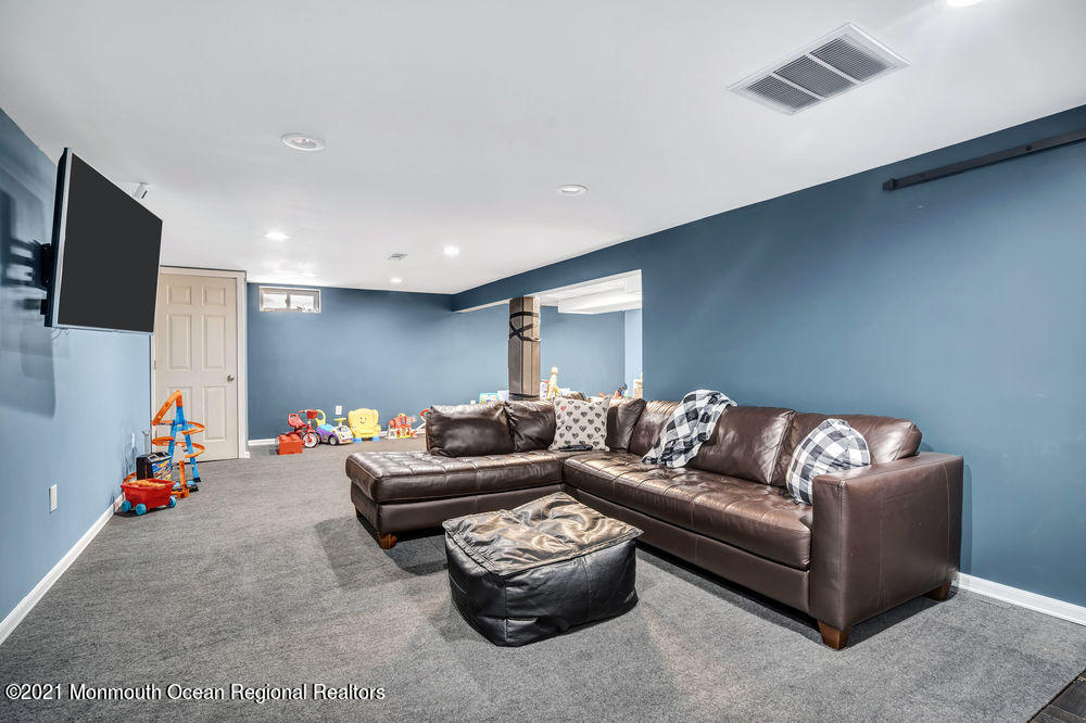 5 Cedar Drive Colts Neck, NJ 07722 - Photo 35 of 41 a living room with furniture and a flat screen tv