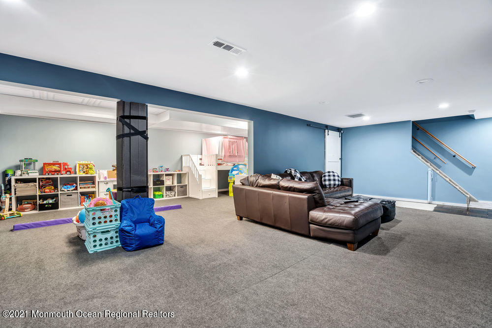 5 Cedar Drive Colts Neck, NJ 07722 - Photo 37 of 41 a living room with furniture and a gym equipment