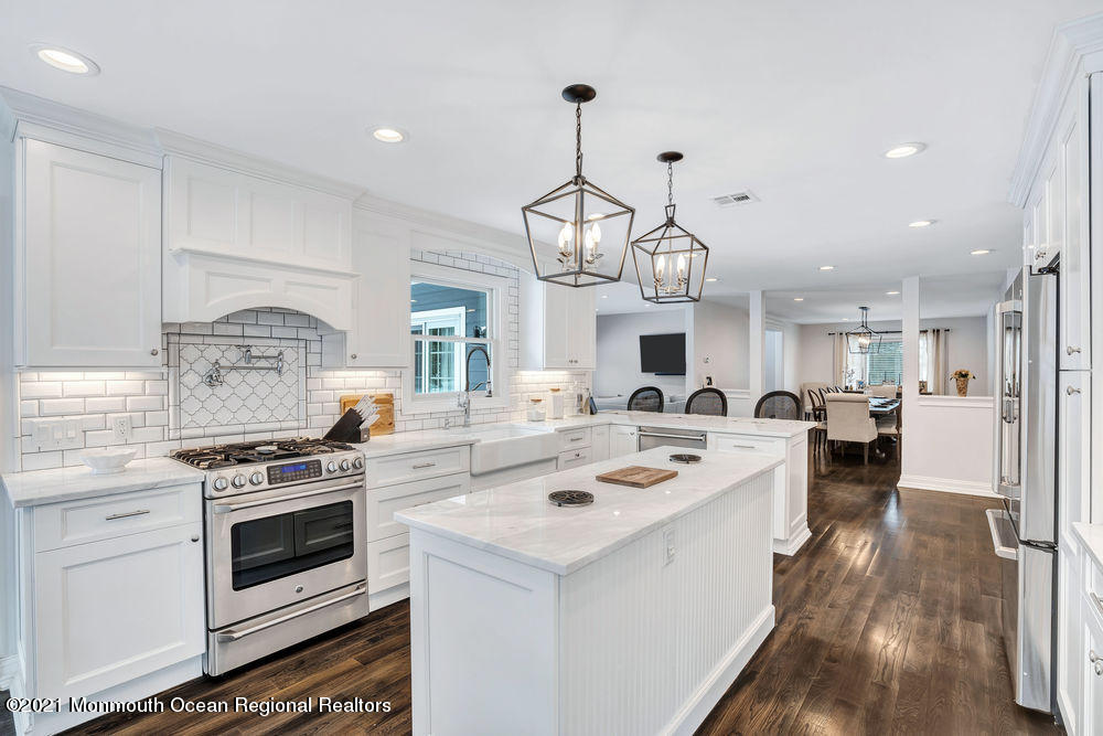 5 Cedar Drive Colts Neck, NJ 07722 - Photo 9 of 41 a kitchen that has a lot of white cabinets and stainless steel appliances