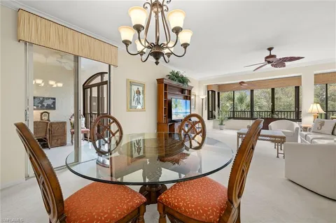 a view of a dining room with furniture wooden floor and chandelier