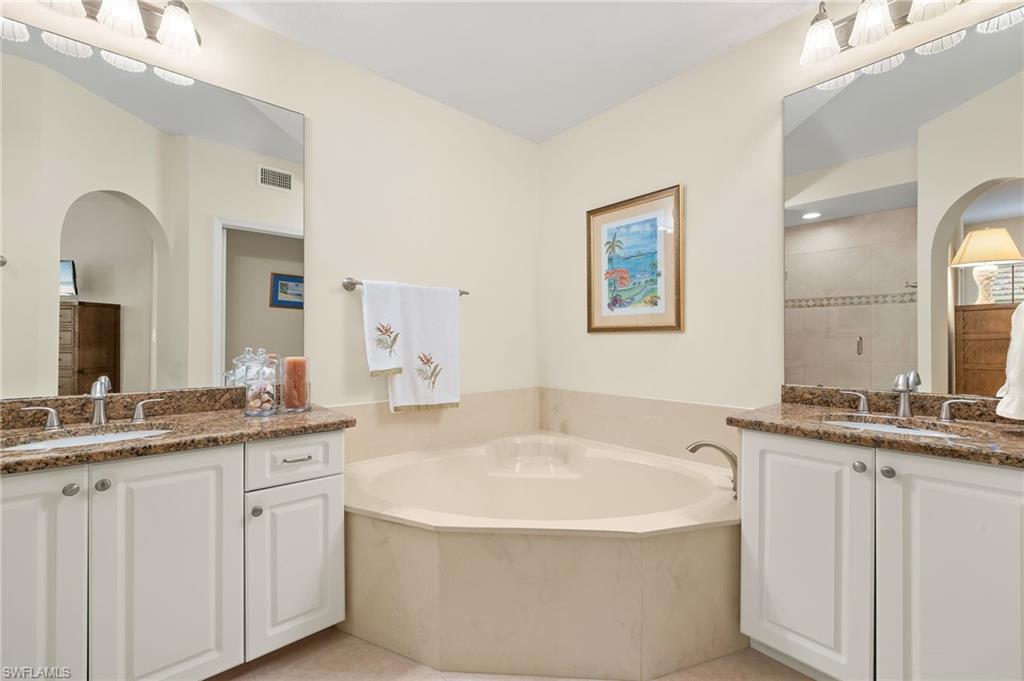 6500 Valen Way, Unit A203 Naples, FL 34108 - Photo 7 of 18 Bathroom featuring a garden tub, a stall shower, and a sink