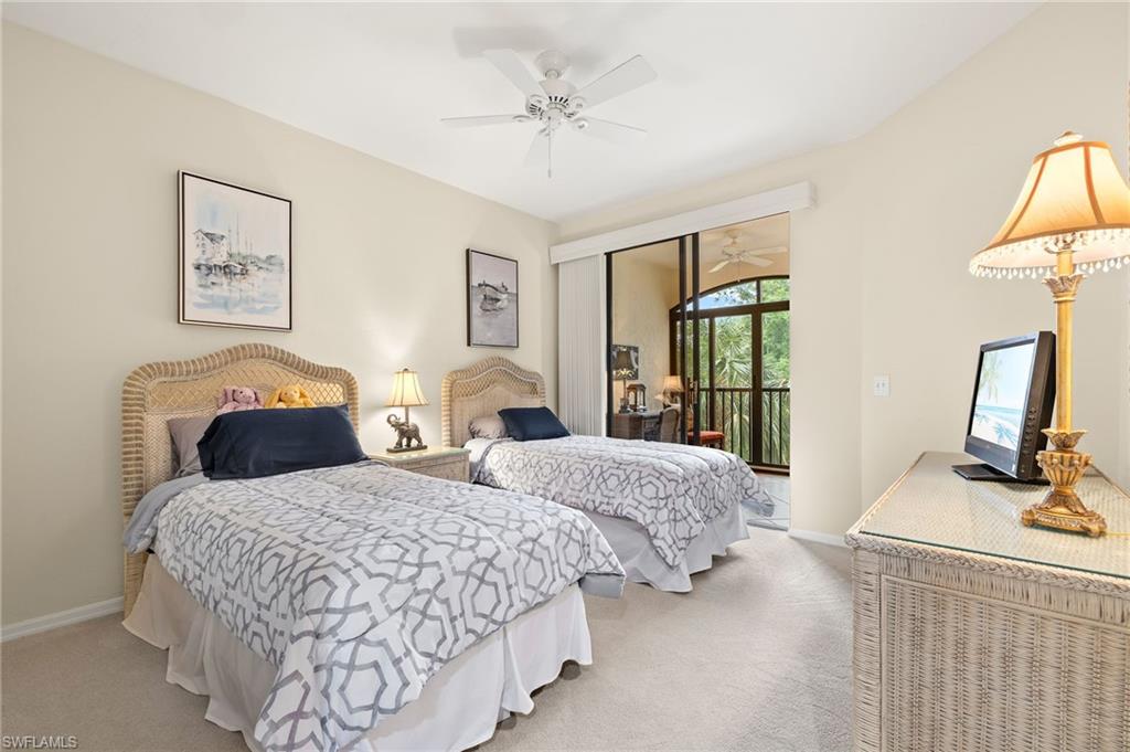 6500 Valen Way, Unit A203 Naples, FL 34108 - Photo 9 of 18 Bedroom with light colored carpet, ceiling fan, baseboards, and access to outside