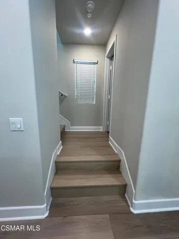 a view of a hallway to rooms