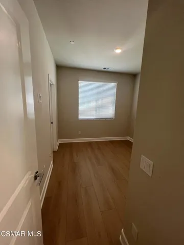 an empty room with a empty space and windows