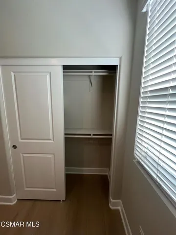 a backyard of a house with barbeque oven table and chairs