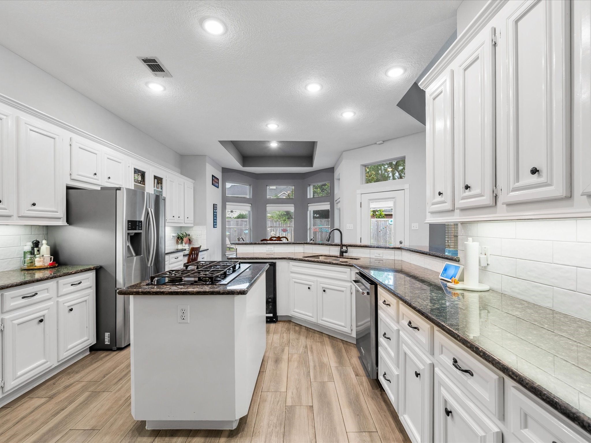 5910 Center Ct Drive Spring, TX 77379 - Photo 16 of 50 This expansive kitchen invites you to imagine cooking, gathering, and entertaining with ease in a space designed for both everyday living and elevated occasions, complete with a wine cooler for added convenience and enjoyment.