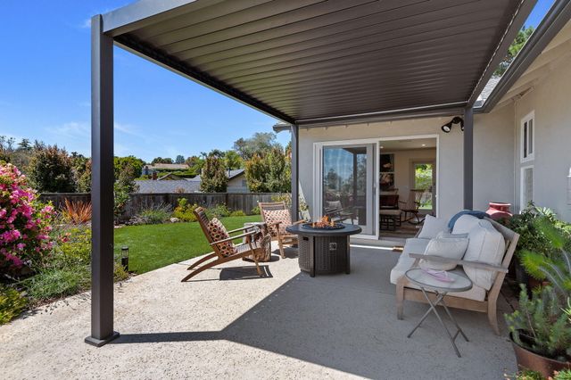 a living room with patio furniture and garden