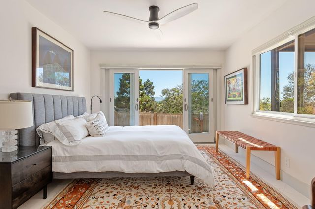 a bedroom with a bed wooden floor and window