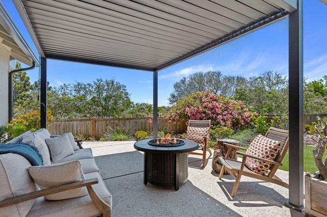 a view of a patio with a table chairs and a potted plants