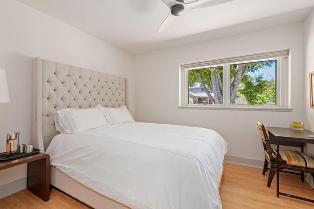 a bedroom with a bed and a table in it