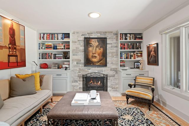 a living room with furniture and a book shelf