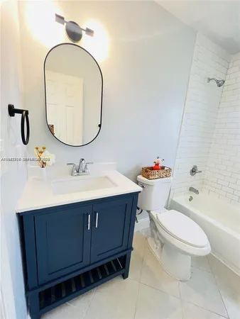 a bathroom with a sink mirror vanity and toilet
