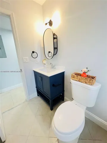 a bathroom with a toilet a sink and a mirror