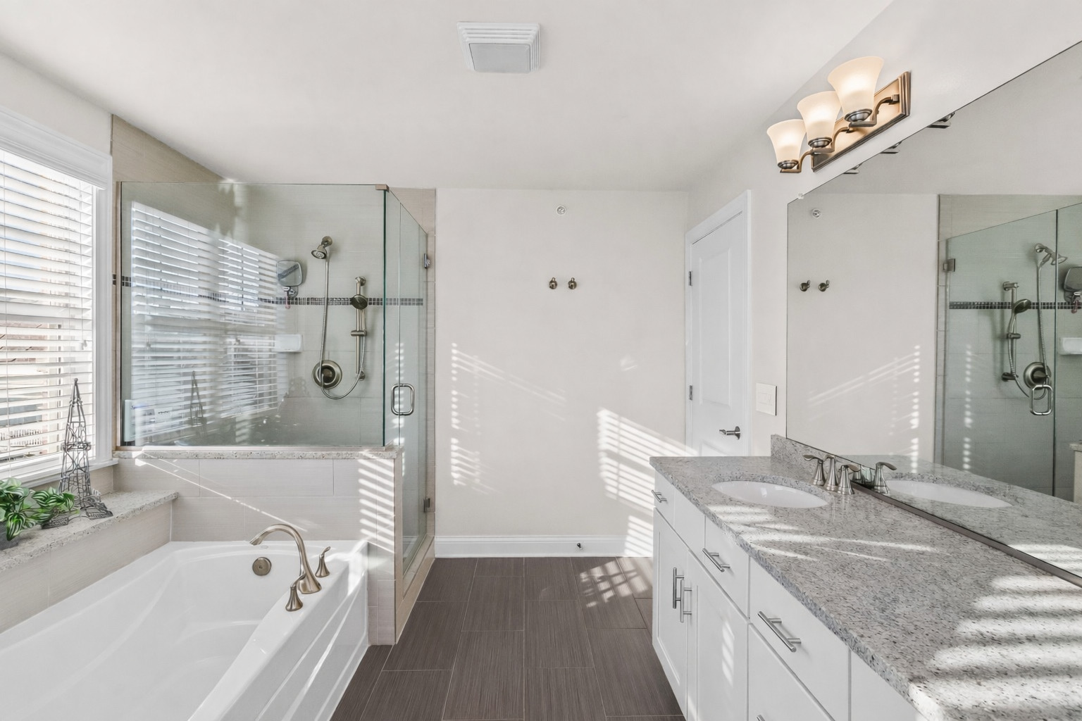 311 South NW Highway, Unit 1 Park Ridge, IL 60068 - Photo 19 of 30 a bathroom with a granite countertop tub a sink and a large mirror