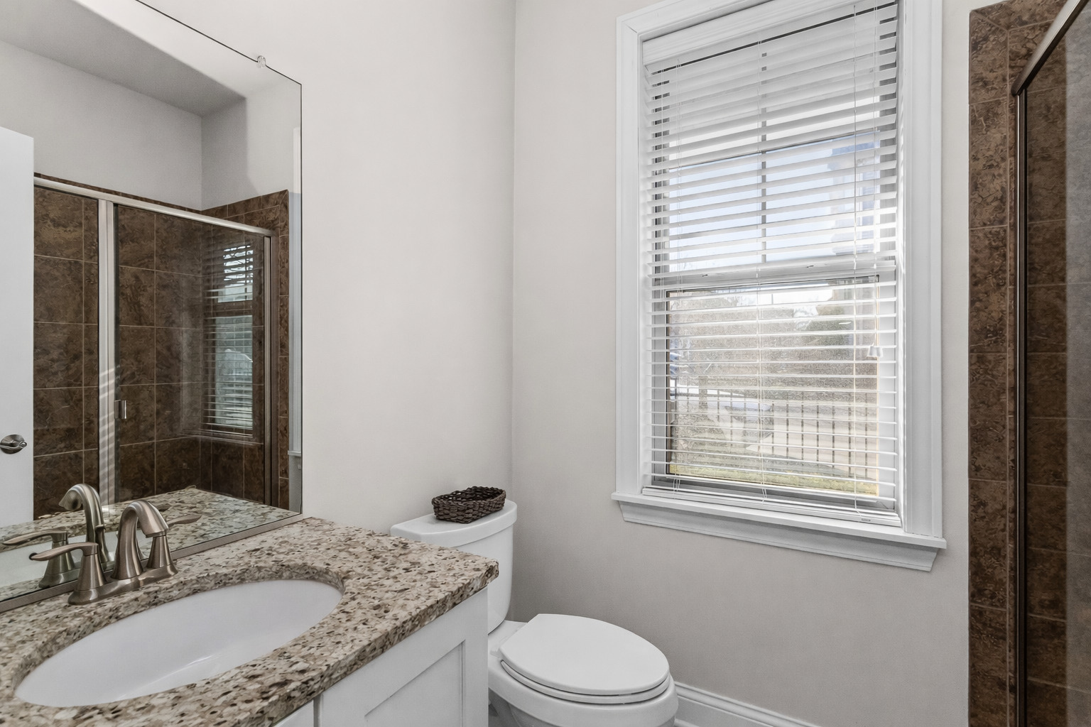 311 South NW Highway, Unit 1 Park Ridge, IL 60068 - Photo 20 of 30 a bathroom with a granite countertop sink toilet a mirror and shower