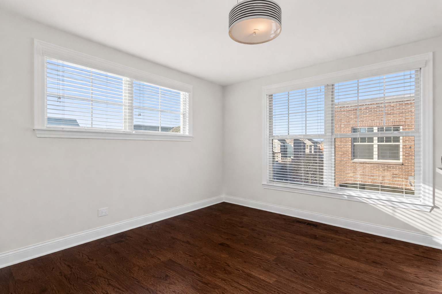 311 South NW Highway, Unit 1 Park Ridge, IL 60068 - Photo 6 of 30 an empty room with wooden floor and windows