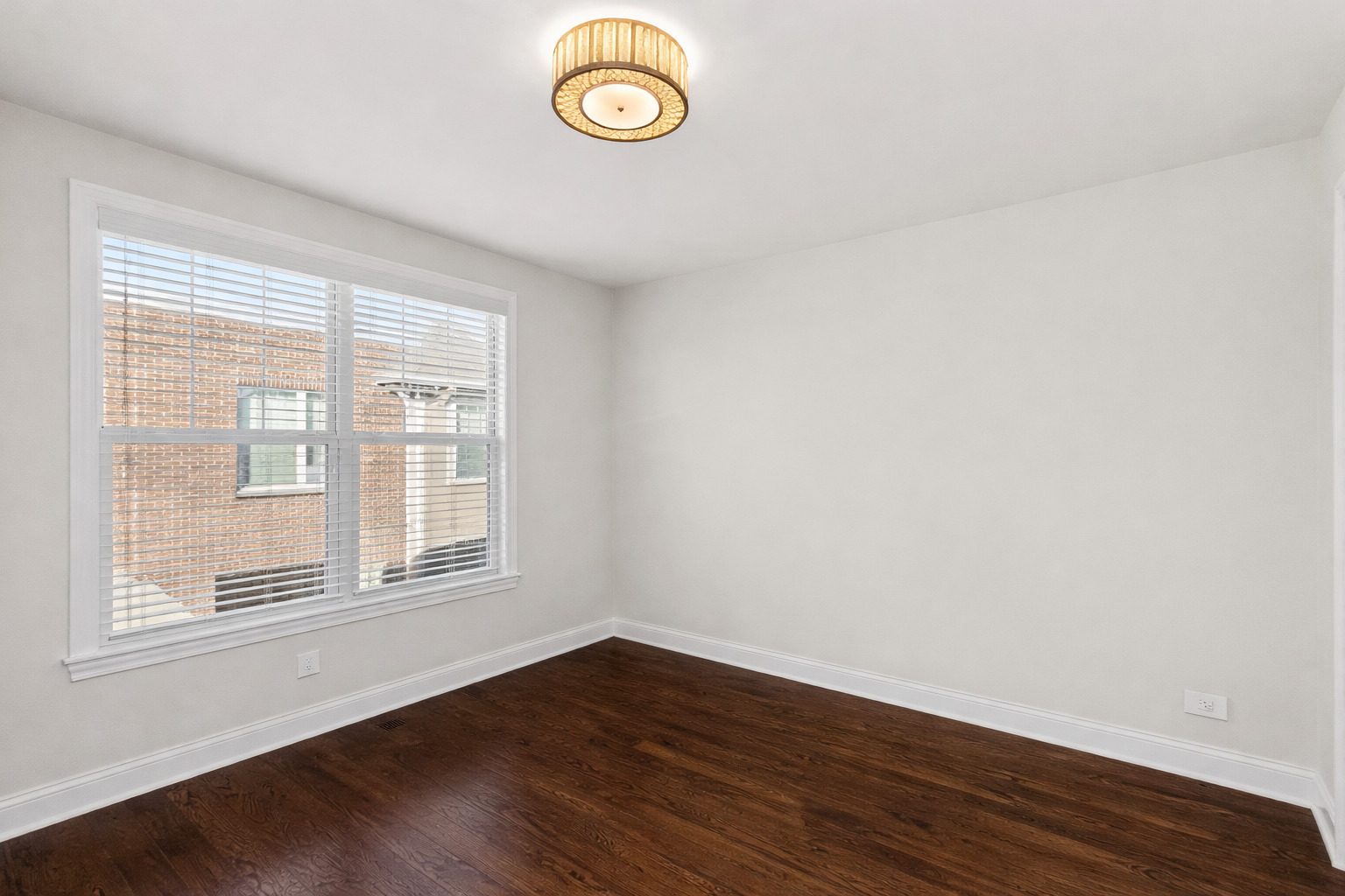 311 South NW Highway, Unit 1 Park Ridge, IL 60068 - Photo 7 of 30 an empty room with wooden floor and window